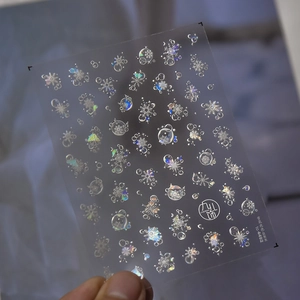 Detail of iridescent shell luster snowflake nail stickers on transparent PET backing