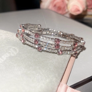 Detail of silver triple-row bracelet with pink rectangular stones on white jewelry box