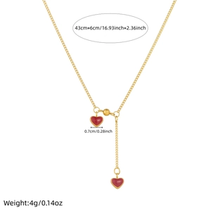 Gold-plated stainless steel Y-necklace featuring burgundy heart pendants and fringe detail