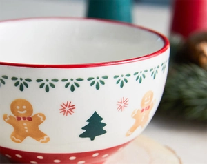 Close-up of ceramic Christmas bowl with gingerbread man, Xmas tree and snowflake patterns