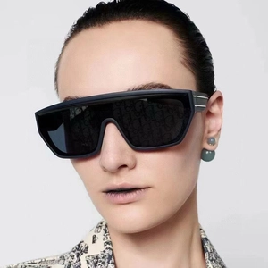 Close-up of oversized square sunglasses with signature oblique pattern on lenses