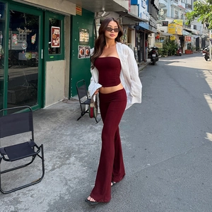 Ensemble deux pièces avec haut bustier bordeaux et pantalon évasé porté avec chemise blanche