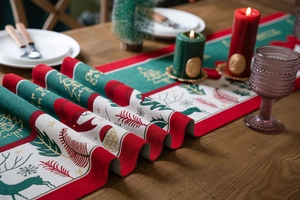 Detailed view of Christmas table runner with festive reindeer and snowflake embroidery