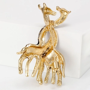 Back view of gold-tone giraffe enamel brooch with secure pin clasp on white pedestal