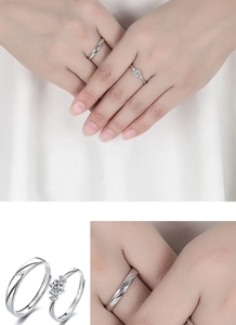 Detail of silver couple rings set featuring a three-stone female ring and textured male band
