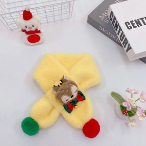 Detail of yellow plush kids scarf with reindeer decor and festive tassels on white background