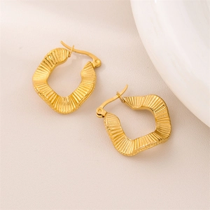 Irregular geometric wavy gold titanium steel hoop earrings with a matte textured finish