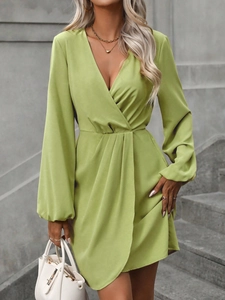 Elegant green long sleeve dress featuring a deep V-neck and stylish puff sleeves