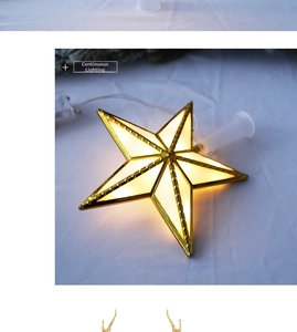 Detail of golden 3D star tree topper with warm white LED light and transparent wire