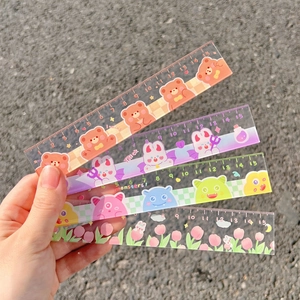 Close-up of four 15cm transparent acrylic rulers with cute cartoon bear and rabbit patterns