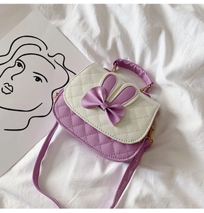 Detail view of purple and white rabbit ear handbag with bow for little girls