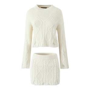 Detail of white cable knit two-piece set with distressed hollow-out design and texture