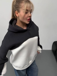 Relaxed oversized hoodie featuring a bold black and white color-block patchwork design