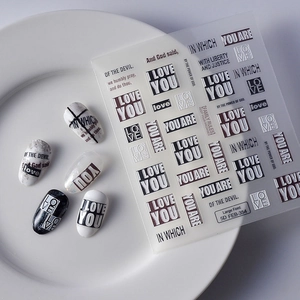 Detailed macro view of 5D embossed nail art stickers with I LOVE YOU letter decals
