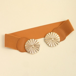 Detail of round gold metal buckle with fan texture on brown elastic waist belt