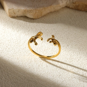 Macro shot of gold-plated double bow open ring on stone texture detail