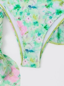 Detailed close-up of floral bikini bottom with ruffles and high-stretch elastic fabric