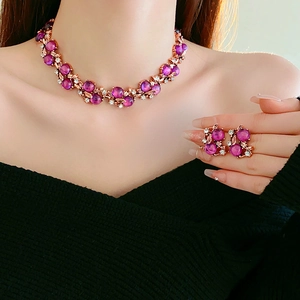 Detail of vintage flower necklace and earring set with purple gems on model