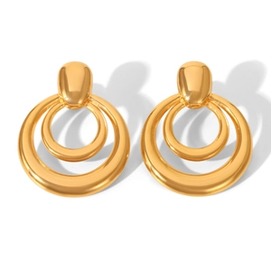 Detailed macro view of gold-plated multi-layer intertwined circular drop earrings