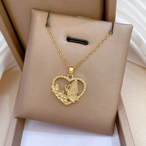 Detailed macro view of heart pendant with butterfly and floral diamond-set design