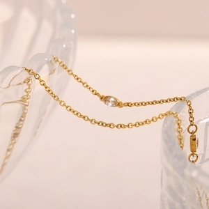Detail of 18K gold plated stainless steel necklace with marquise-cut zircon pendant