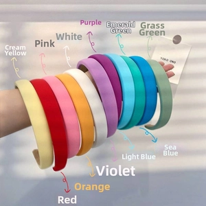 Detailed row of thick sponge headbands in various bright candy colors on an arm