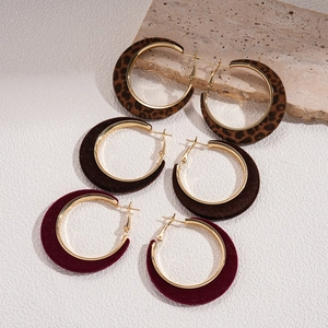 Three pairs of velvet flocked geometric hoop earrings in leopard, brown, and burgundy