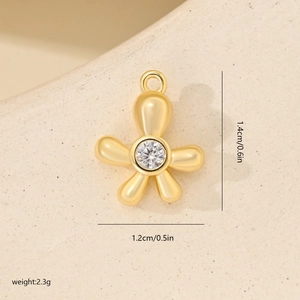 Macro detail of a gold flower pendant with cubic zirconia and exact size dimensions