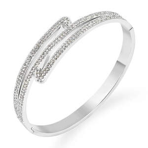 Polished silver stainless steel bangle featuring a pavé crystal double cross design