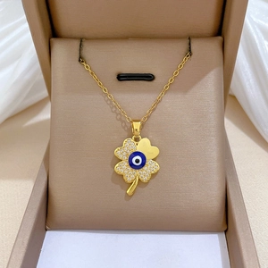 Macro detail of a clover evil eye necklace with crystals in a velvet jewelry box