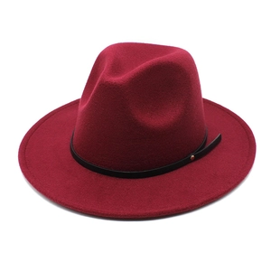 Elegant wine red wool fedora hat with black leather band and gold buckle on white background