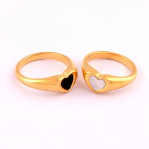 Close-up of 18K gold plated heart rings with black and white epoxy resin inlays