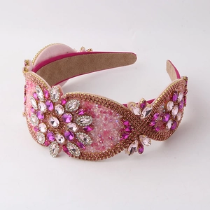 Detailed macro of pink baroque headband featuring crystal rhinestones and gold bead trim