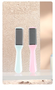 Close-up of dual-sided stainless steel foot files in blue and pink for callus removal