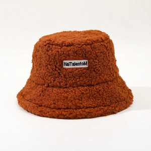 Detail of caramel faux shearling bucket hat with white HaiTalentoM embroidered label