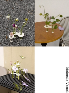 Detail of white wave base molecule vase with glass test tubes for floral display
