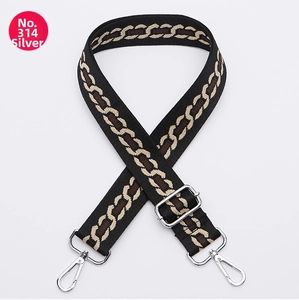 Close-up of adjustable woven shoulder strap with silver hardware and geometric chain pattern