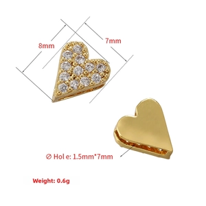 Detail view of heart-shaped gold spacer bead with cubic zirconia and 8x7mm dimensions