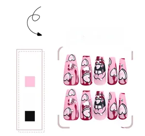 Detailed view of pink coffin press-on nails with heart rhinestones and drip art