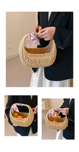 Detail of hand-woven crescent rattan handbag decorated with a pink patterned silk scarf