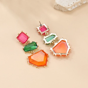 Detail view of colorful geometric drop earrings with pink, green and orange resin stones