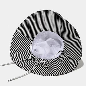 Wide brim sun hat with black and white vertical stripes and matching adjustable ribbon tie
