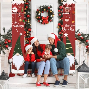 Red Christmas door banners featuring Santa and reindeer at a cozy family porch