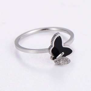 Elegant silver butterfly ring with black enamel and frosted texture on white background