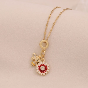 Charming gold-tone necklace with enamel bee and rhinestone four-leaf clover charms