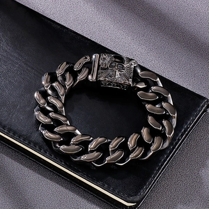 Macro shot of Cuban chain link bracelet with detailed skull embossed metal clasp