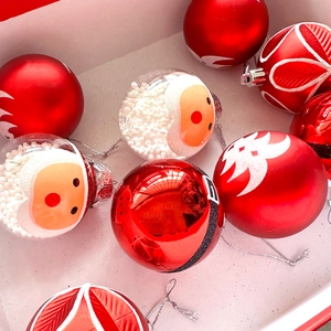Detail of red and transparent 6cm Christmas ornaments with Santa Claus and snowflake motifs