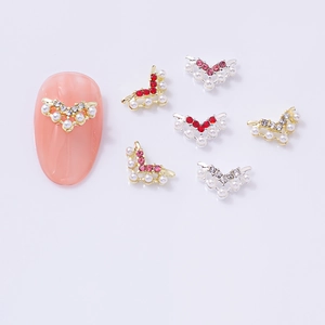 V-shaped alloy nail art charms with colorful rhinestones and pearls on white background