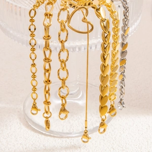 Detail of woven leaf patterns and assorted gold and silver titanium steel bracelets