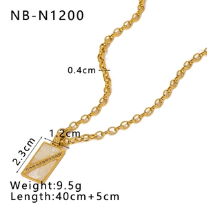 Detail shot of golden necklace featuring a shell inlaid pendant with small crystals